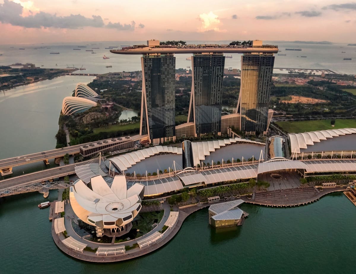 Aerial view of Marina Bay Sands and the ArtScience Museum, with Gardens by the Bay and the Singapore Strait beyond